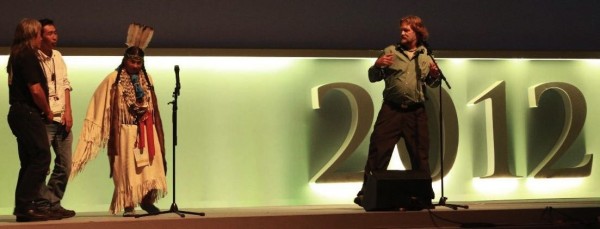 Chief Calleen Sisk on stage at the World Conservation Congress in Jeju Korea, 2012. Along side film maker Christopher (Toby) Mcleod, Chief Caleeen Sisk speaks to the film segments of a forthcoming documentary series that shows the current threats to the sacred natural sites of the Winnemen Wintu.