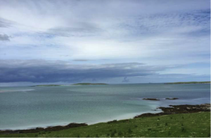 The Isle of Boreray, seen as two low humps with a beach in between when viewed from the spot on North Uist. Alatair and Verene paddled the 2 miles out from the point by Siabaigh, Isle of Berneray, jutting out on the right.Photo: Alastair McIntosh.